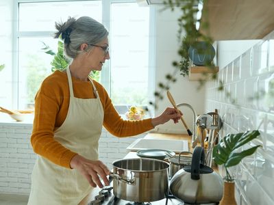 A confident woman cooking in her kitchen