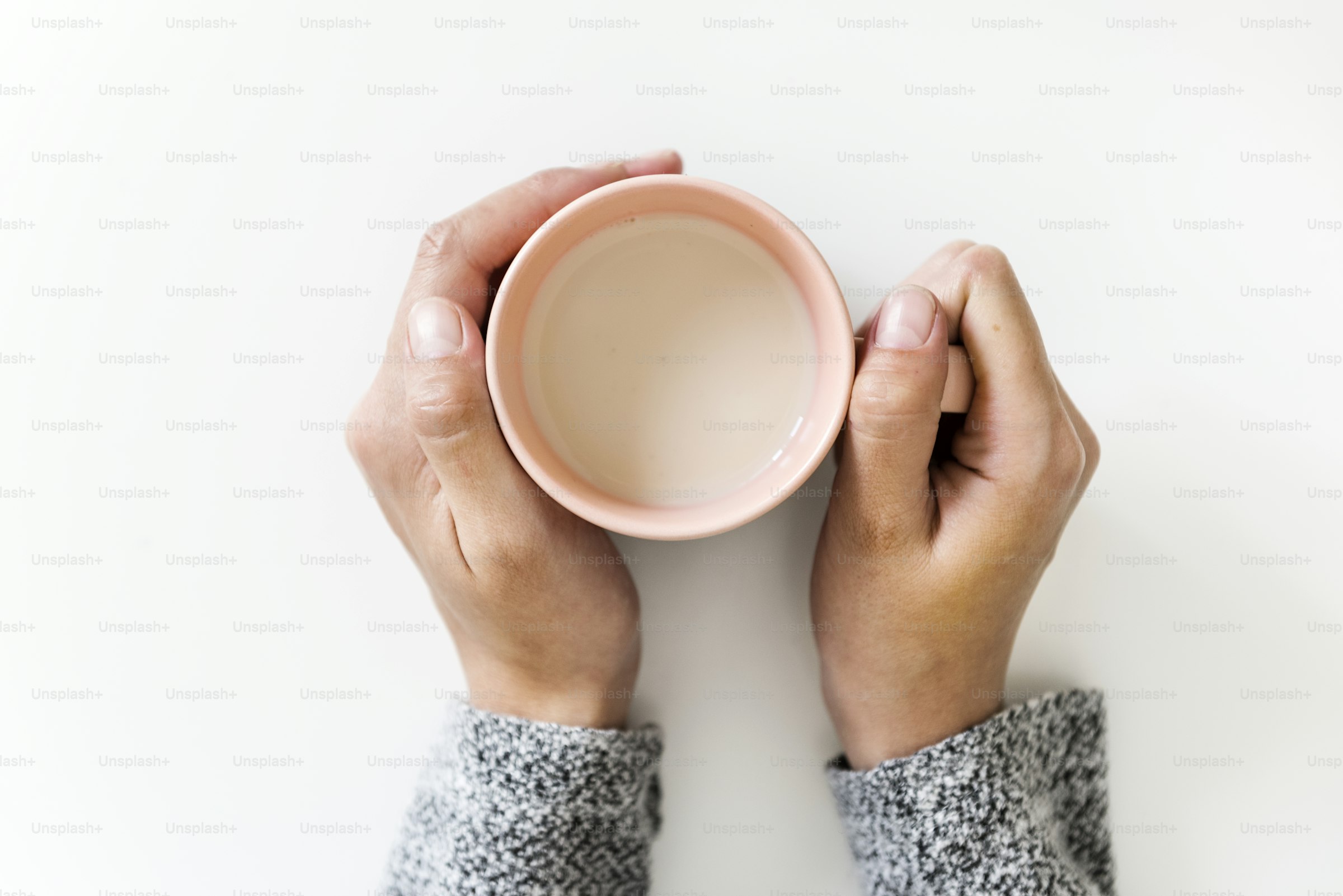 A woman holding a warm drink at home