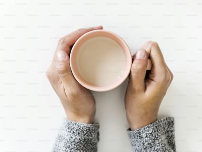 A woman holding a warm drink at home