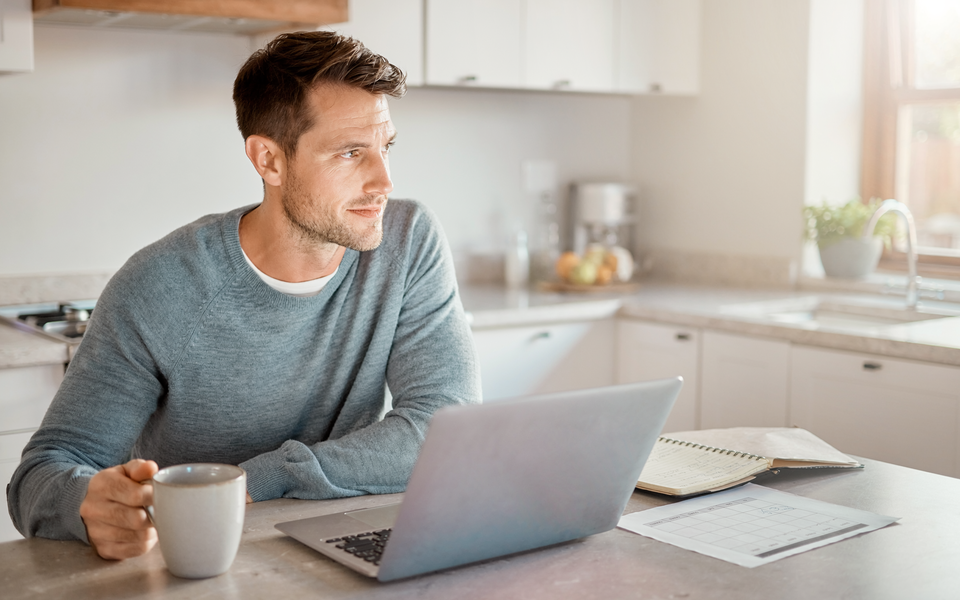Adult arranging a healthcare appointment on a laptop at home.