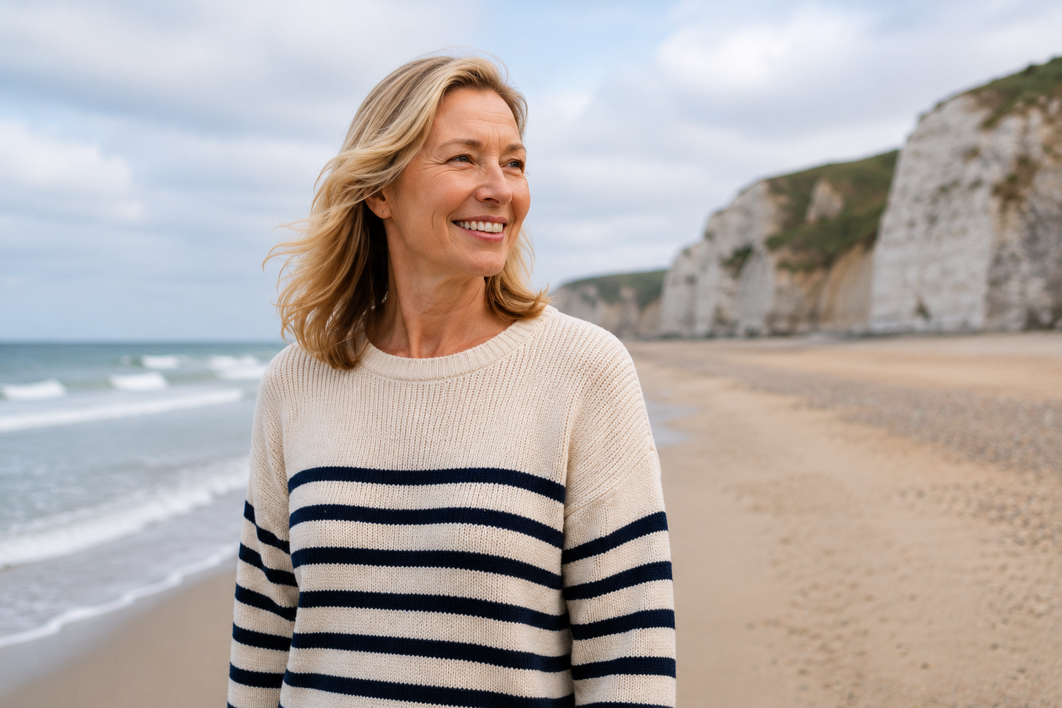 A smiling woman in her forties sitting outdoors