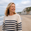 Woman walking on a beach in fresh sea air, positive and energised.