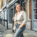 Adult walking briskly through London on a weekday morning.