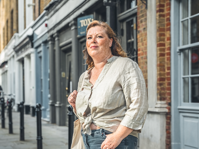 Adult walking briskly through London on a weekday morning.
