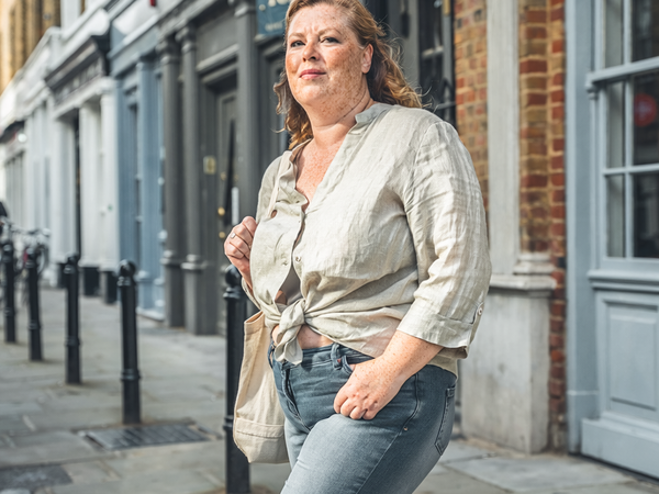 Adult walking briskly through London on a weekday morning.