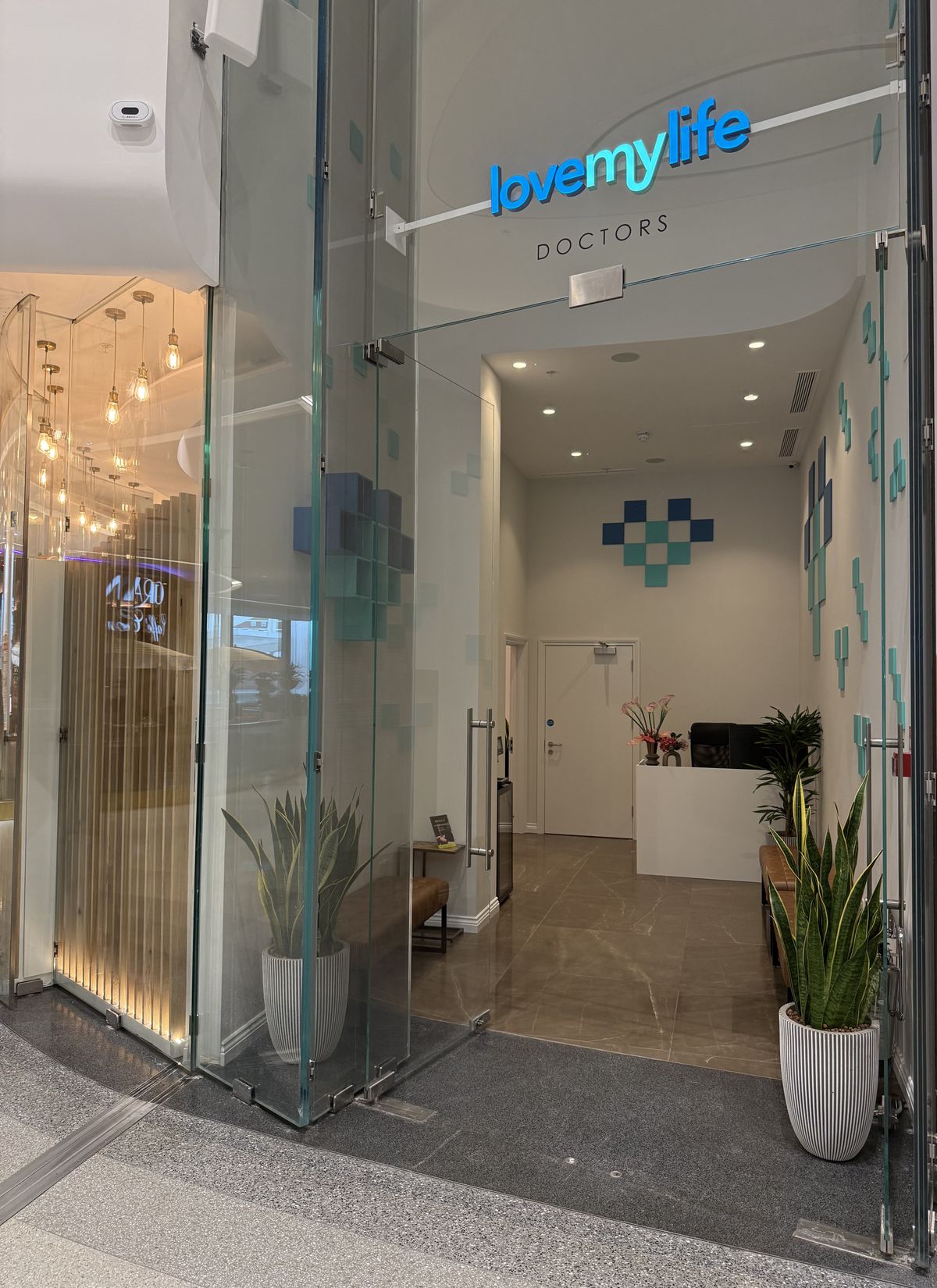 The open glass doors of the LoveMyLife clinic at The Village, Westfield London