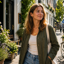 A young European woman walking along a sunny city street