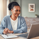 A person comparing healthcare payment options on a laptop at a tidy home desk, considered
