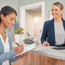 A young newcomer at a friendly GP reception desk completing a registration form, welcoming setting