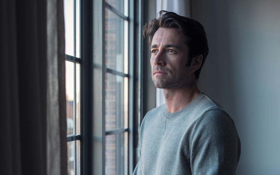 Man in his forties at home in natural morning light.