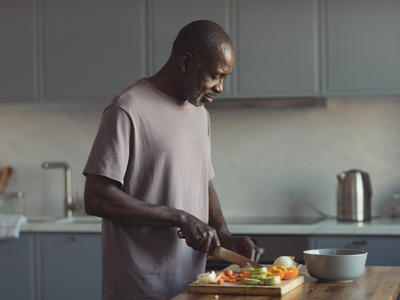 Adult preparing a simple meal in a modern home kitchen.
