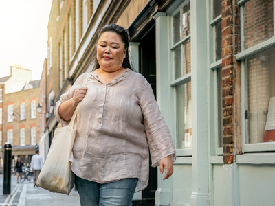 Adult walking briskly through London on a weekday morning.