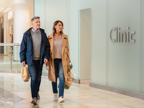 A couple walking past the LoveMyLife clinic at Westfield London