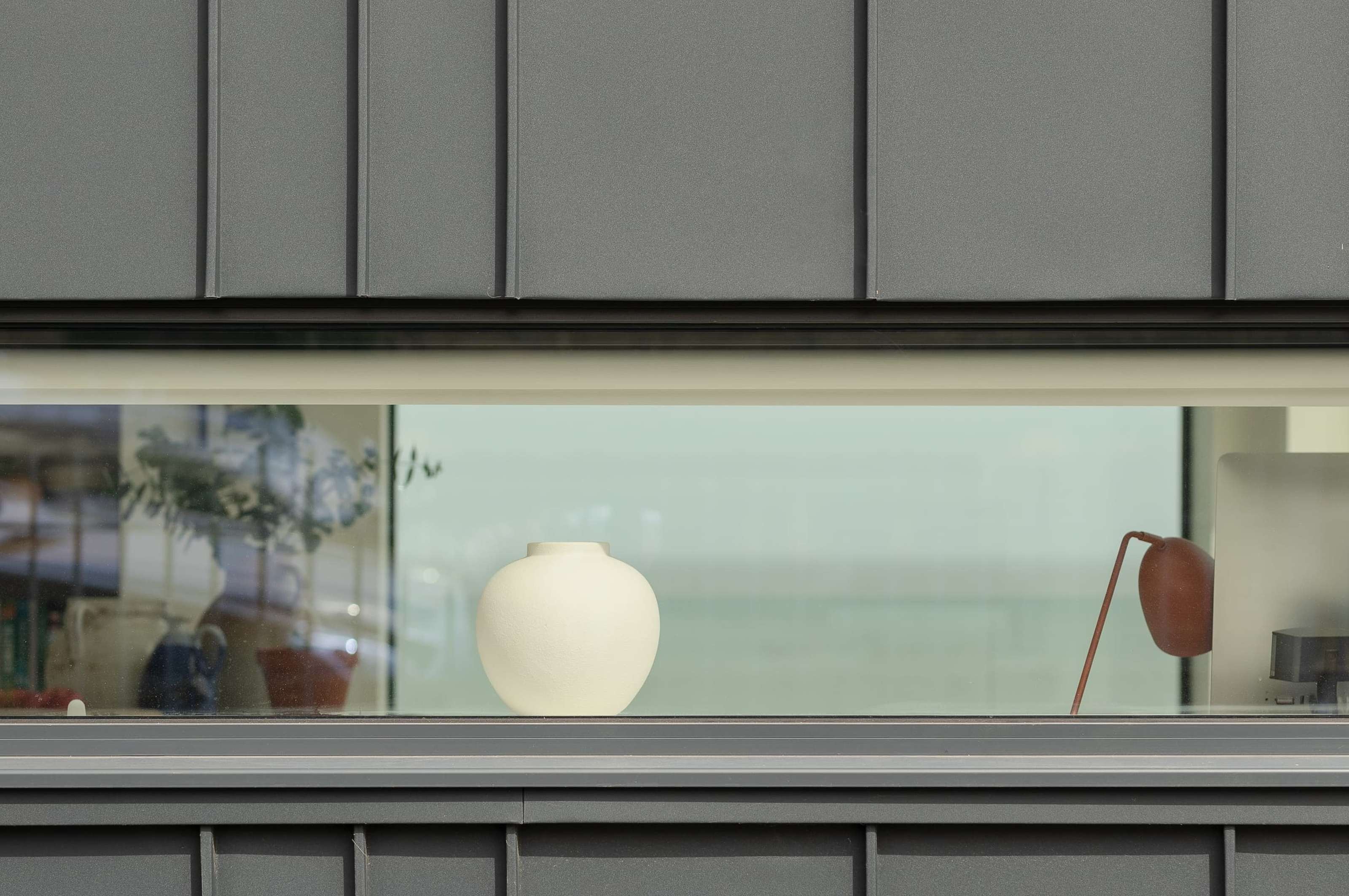 A narrow horizontal Fluid aluminium casement window at Sea Breeze
