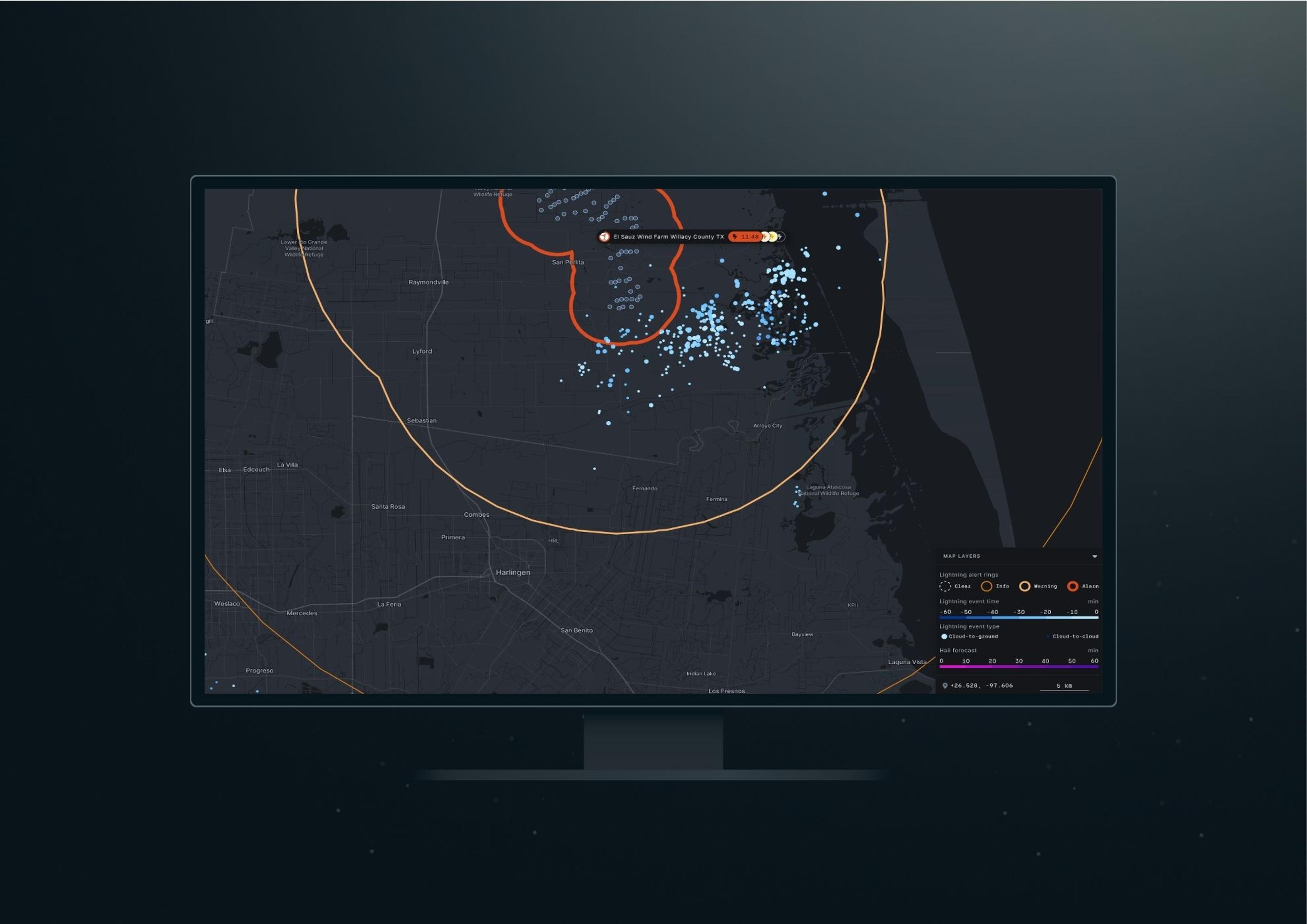 Xweather Protect software with weather layers and alert rings displayed on a monitor