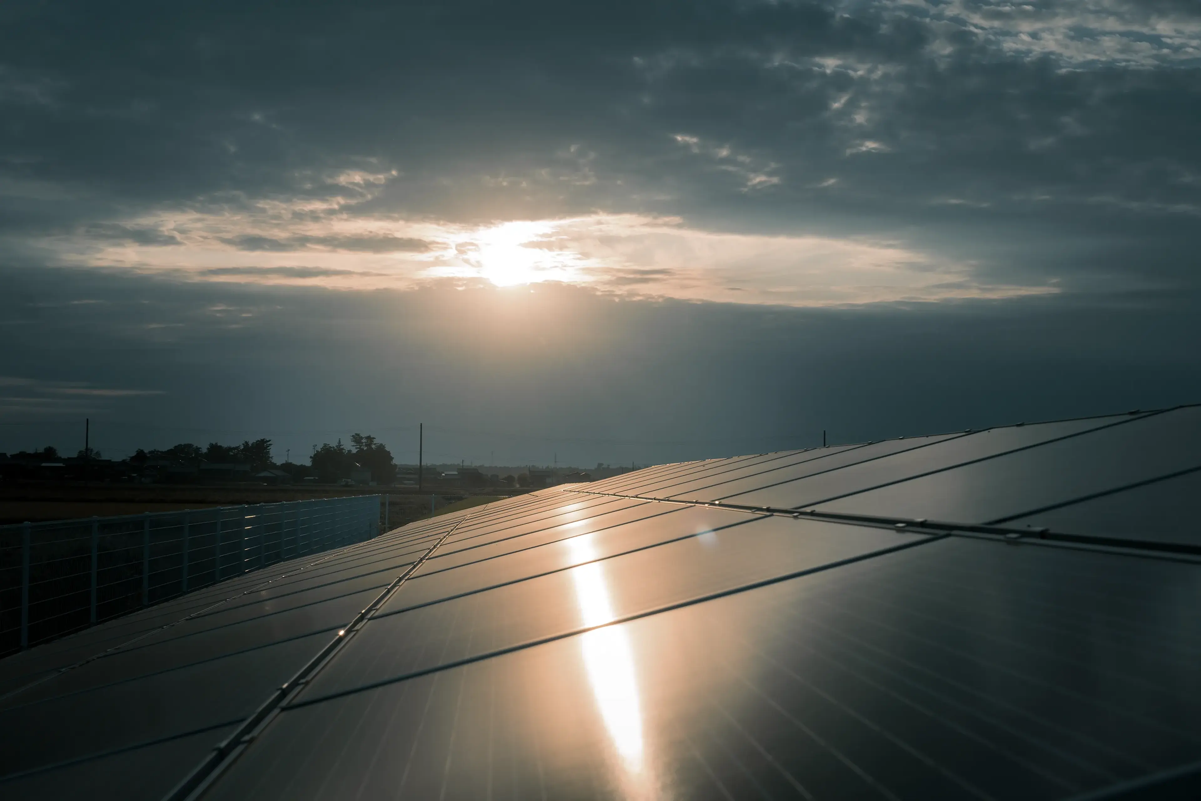 Solar panels under dark storm clouds