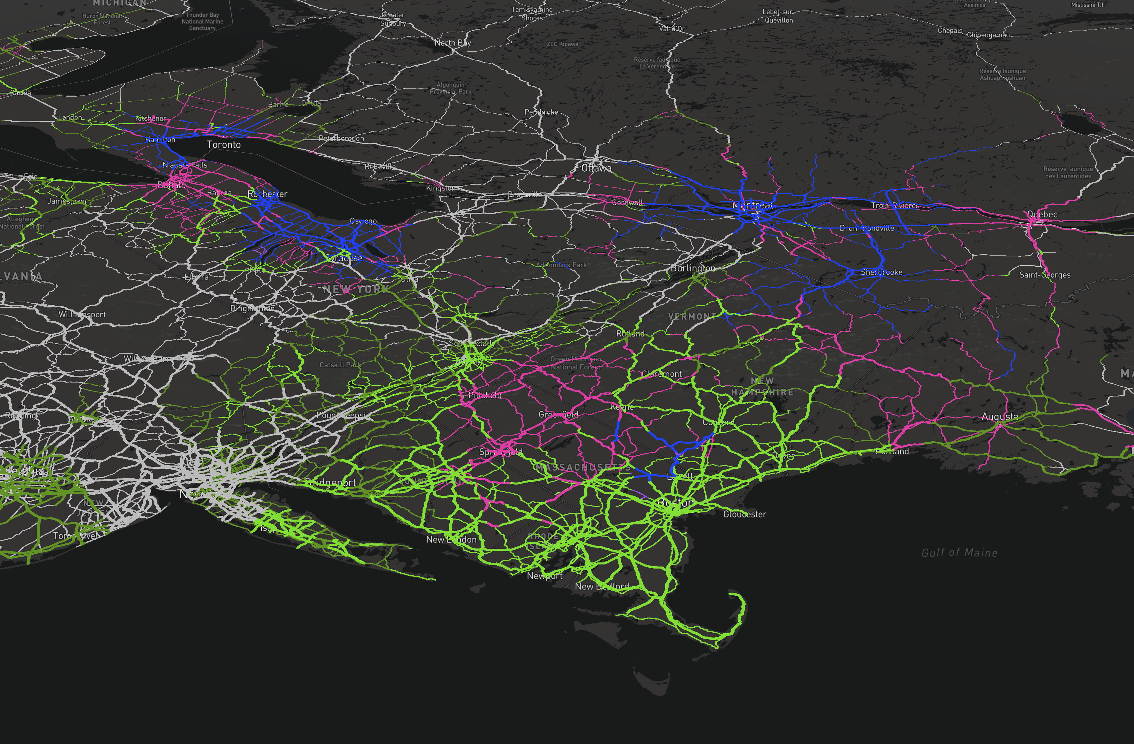 A map showing a network of colorful interconnected lines (green, pink, blue) over a dark background with geographic labels like Toronto.