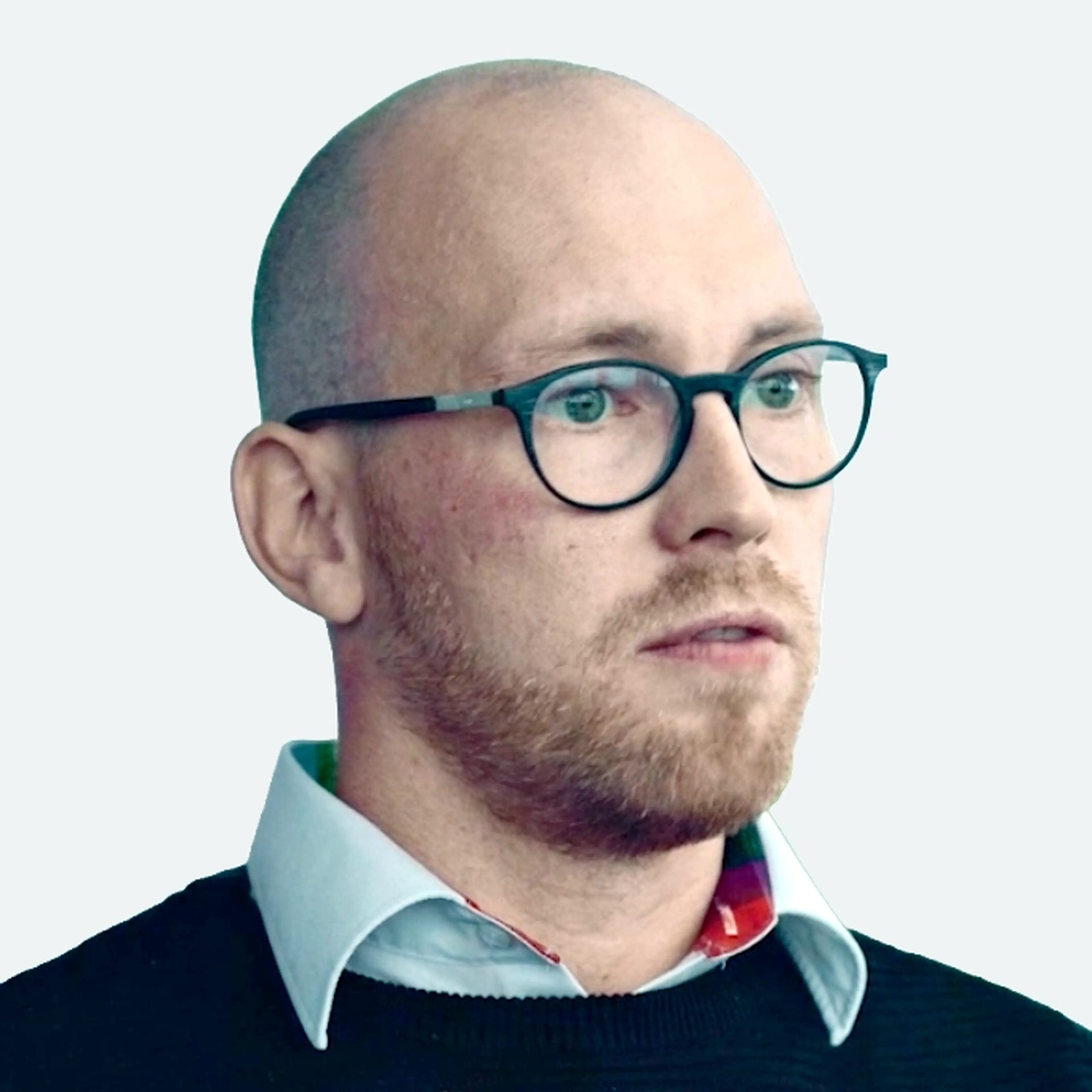 Photo of Christian Jeschke, a man with glasses and a beard, wearing a collared shirt and sweater