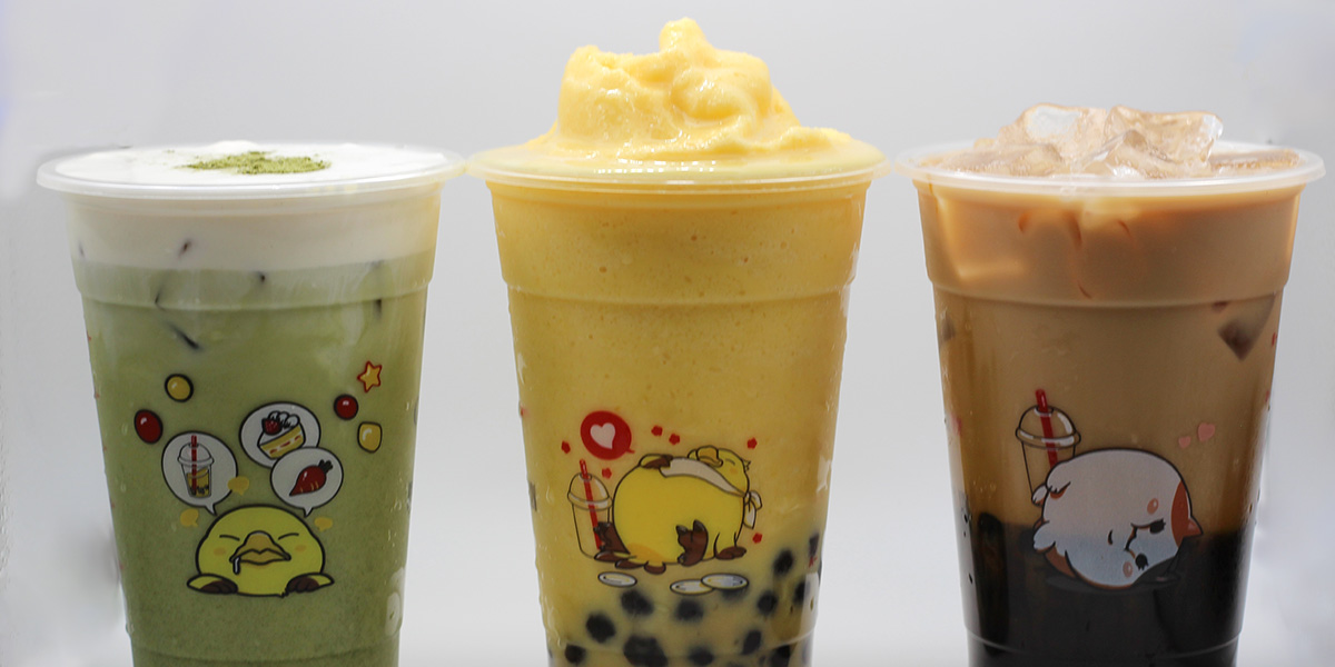 Three Gong Cha cups: matcha cream, mango boba slush with pearls, and iced milk tea — each adorned with cute character stickers.
