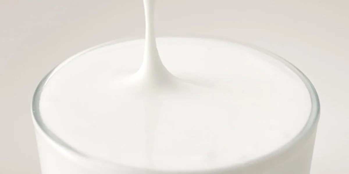 Creamy white milk foam pouring into a glass, silky premium handcrafted topping for Gong Cha drinks.