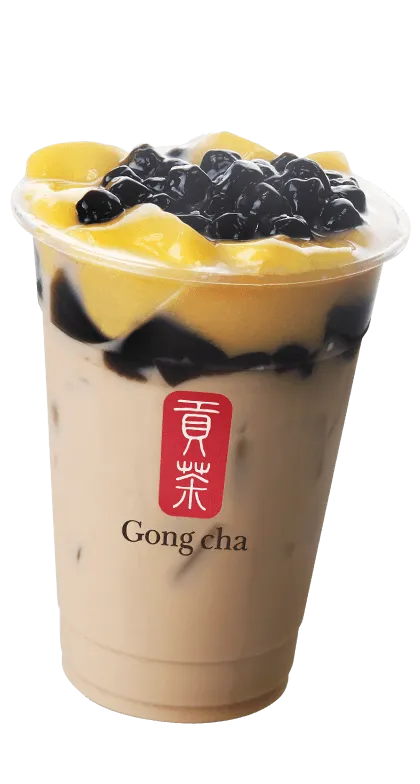 Bubble tea with creamy base, chewy tapioca pearls, and fresh mango chunks in a clear Gong Cha cup.