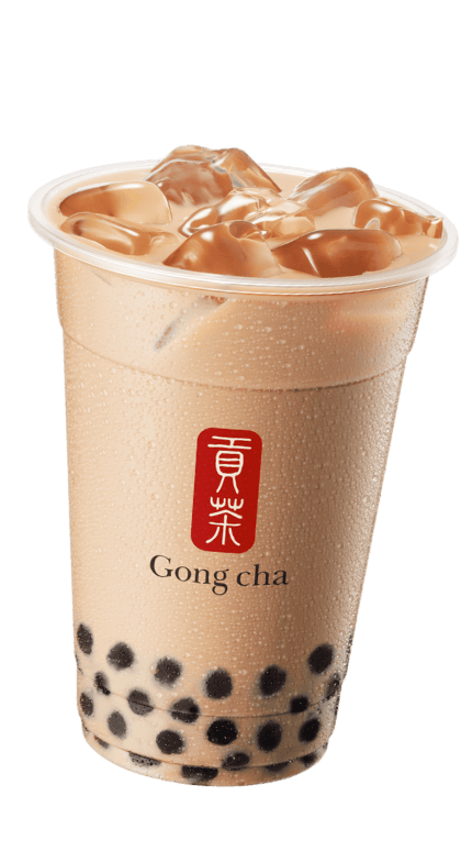 A cup of Gong Cha dolce milk coffee with ice and tapioca pearls, showcasing a smooth brown beverage in a clear plastic cup.