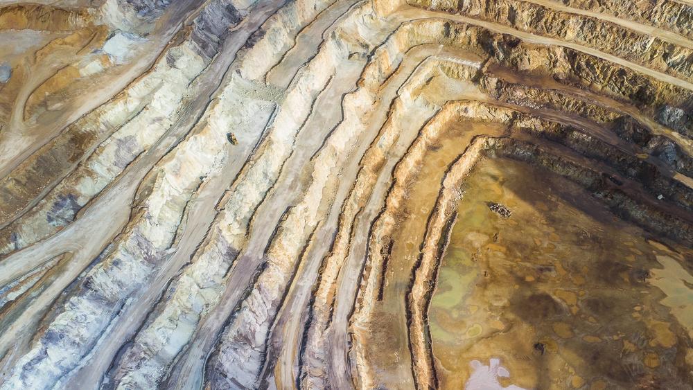 Deep excavation hole of an open pit mine for rare earth elements