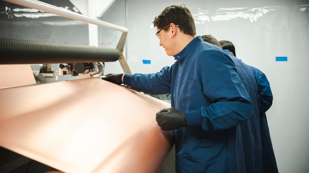Plat worker inspecting a copper foil roll