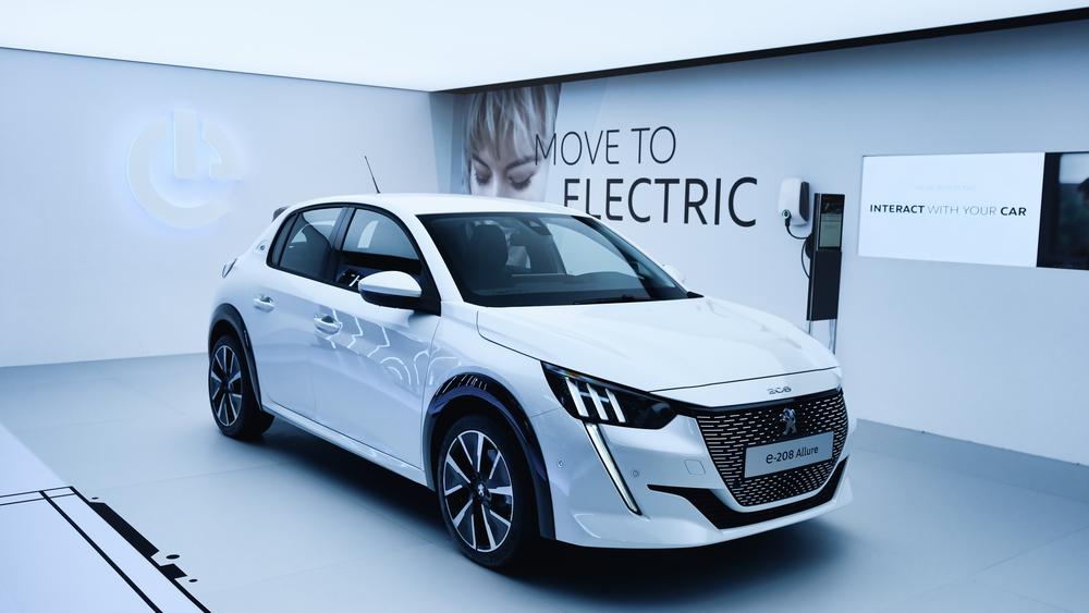 Peugeot 208 electric white clean showroom at the geneva international motorshow, ev car from stellantis group,