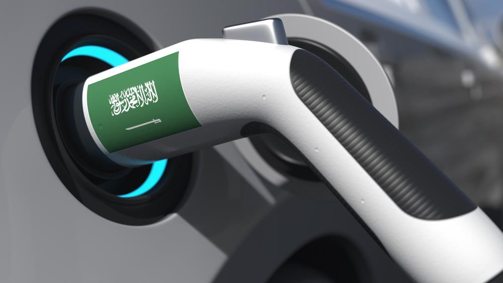 Plug in a modern electric car with flag of saudi arabia. conceptual animation 3D rendering