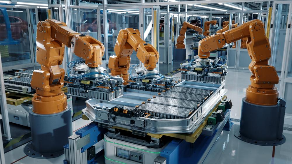 Electric vehicle battery construction by robot arms