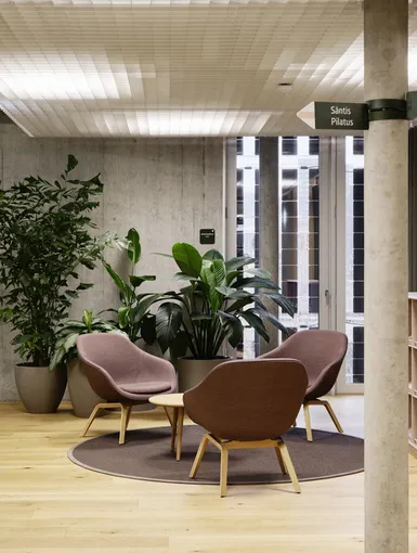 Empfangsbereich mit Stühlen und kleinem runden Tisch.