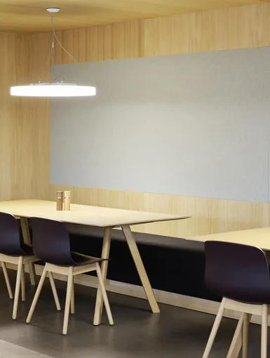 Nische in der Cafeteria mit Stühlen und Tischen.