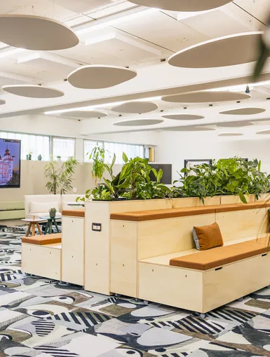 Modernes Open-Space Büro mit hellen Möbeln und kreativem Teppichdesign