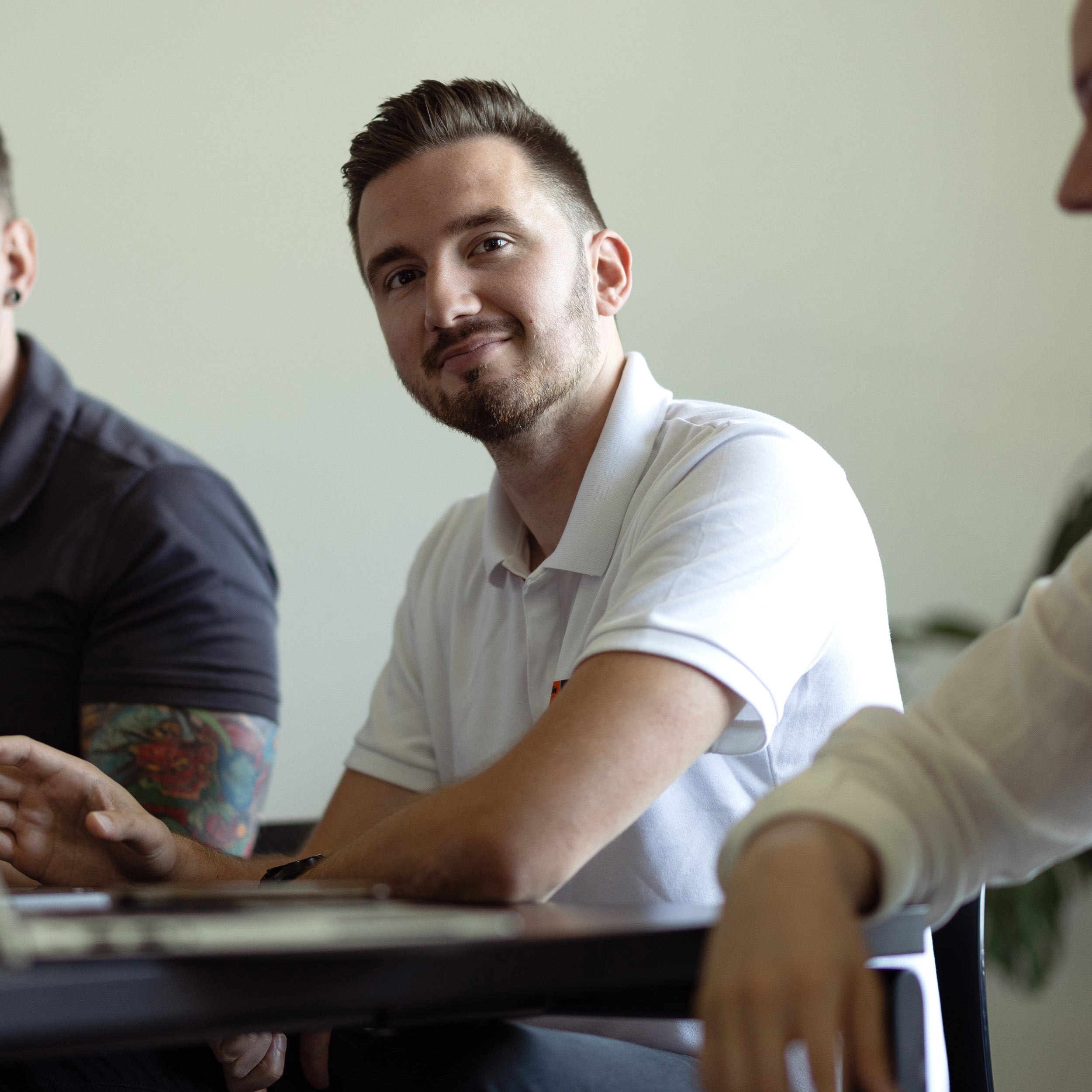 A friendly employee looking straight into the camera.