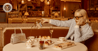 A woman pouring tea in the Savoy