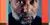 Portrait of a man with a beard and intense gaze, set against a multicolored, textured background.