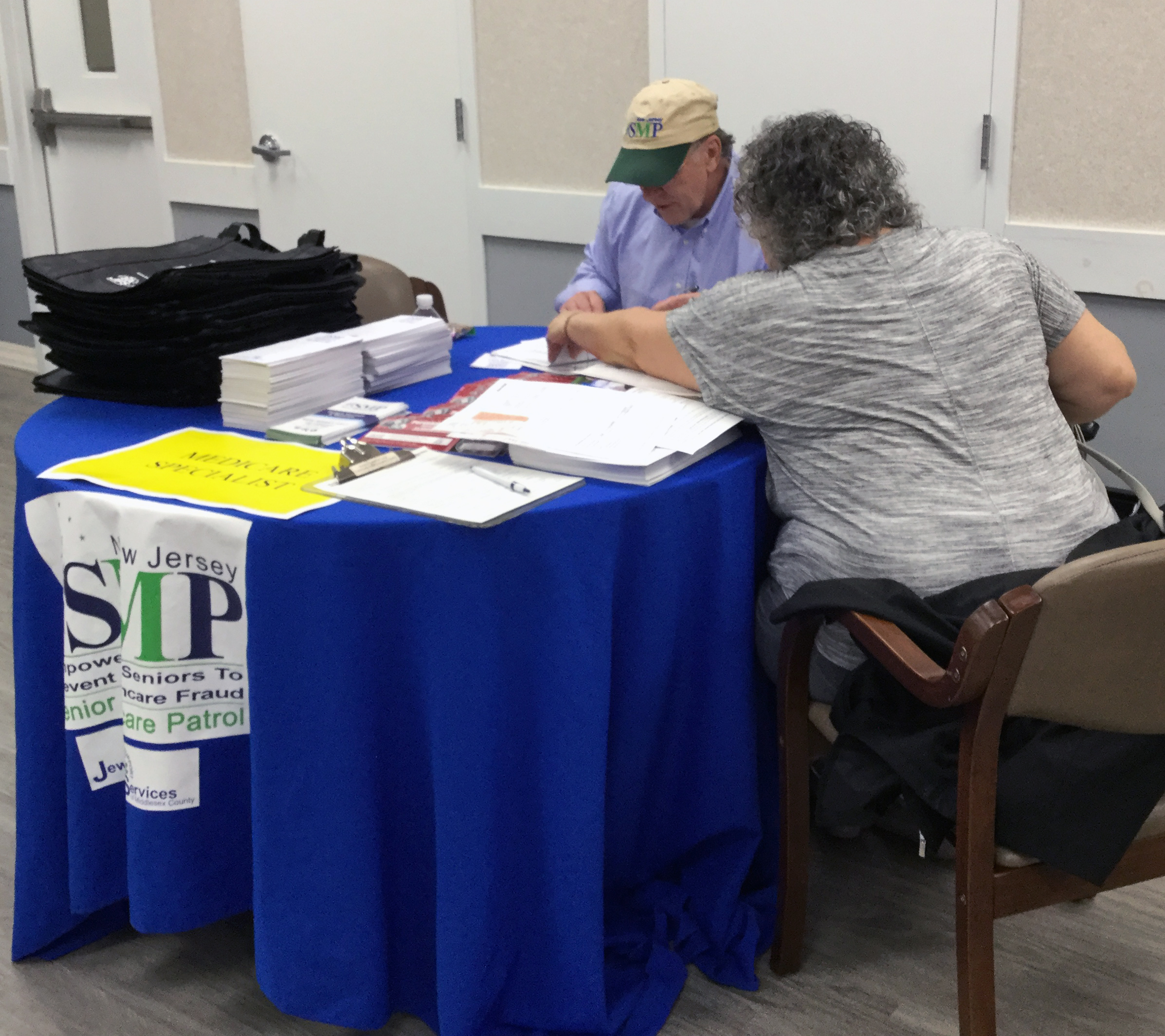 woman helping resident with medicare file