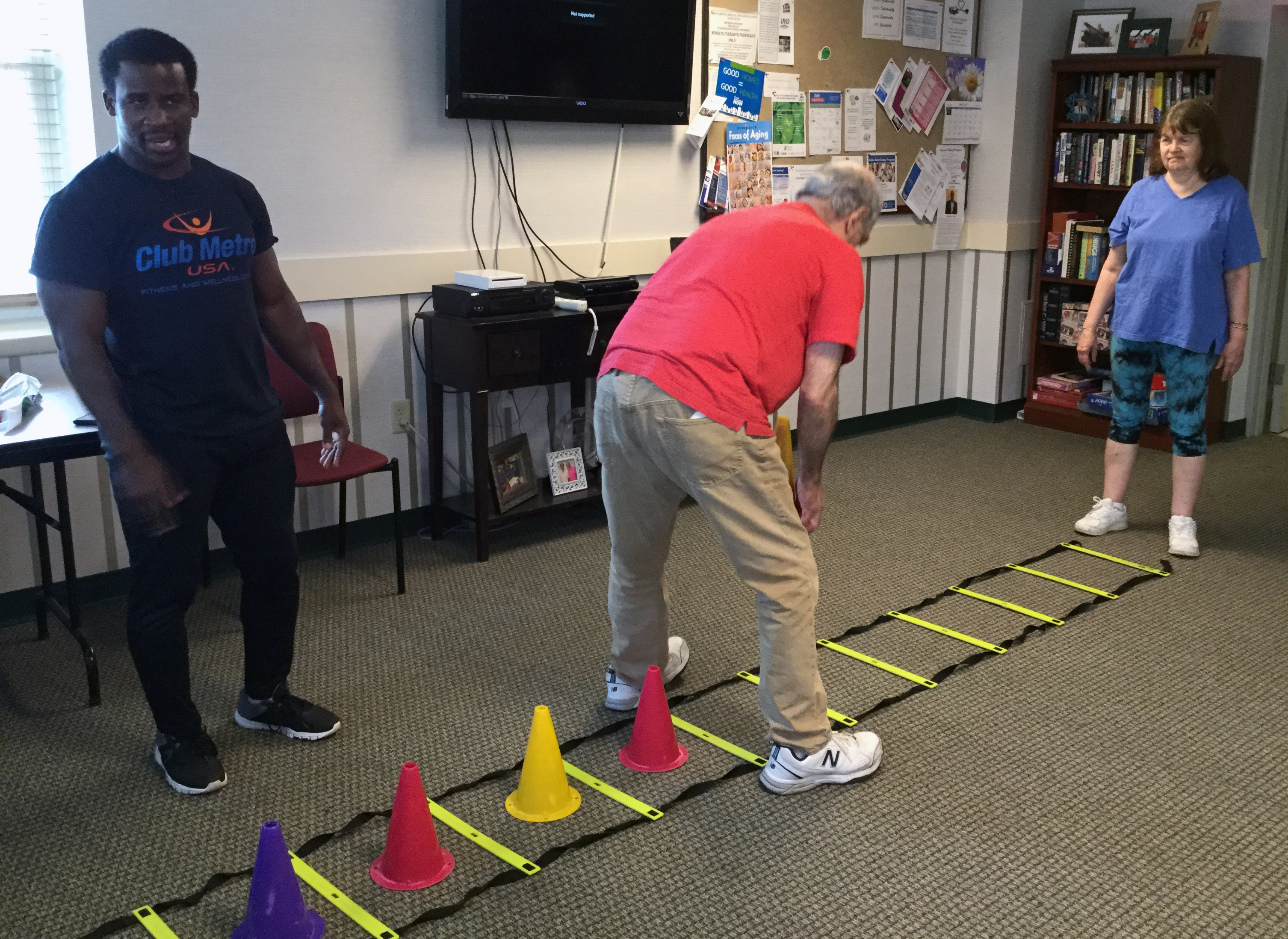 residents exercising with ladder