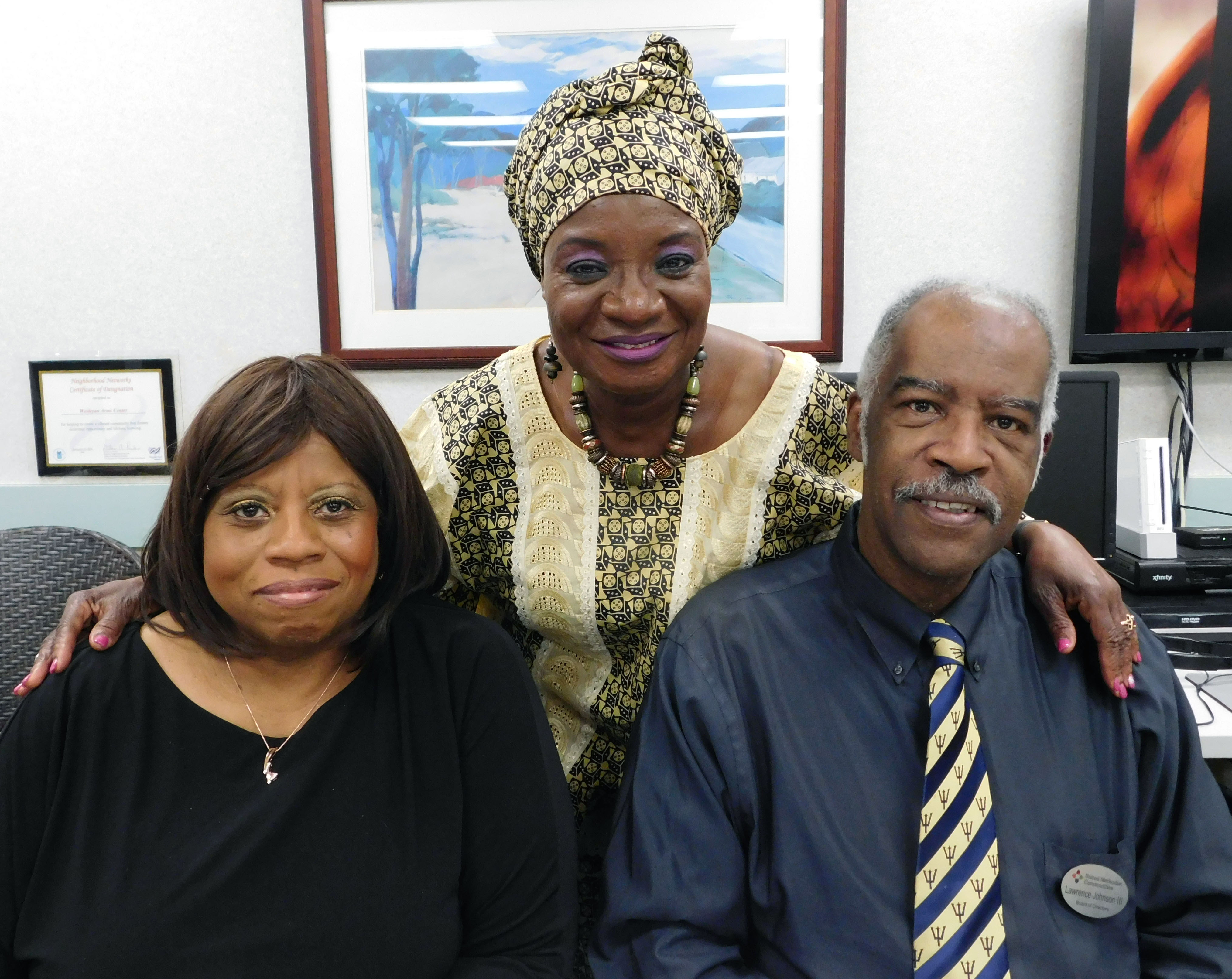 At The Wesleyan’s annual Black History Month celebration, Gertrude (center) greets Lawrence Johnson, III (right), member of the community’s governing board, 9 Wall Street Corporation, and his wife, Terita (left).