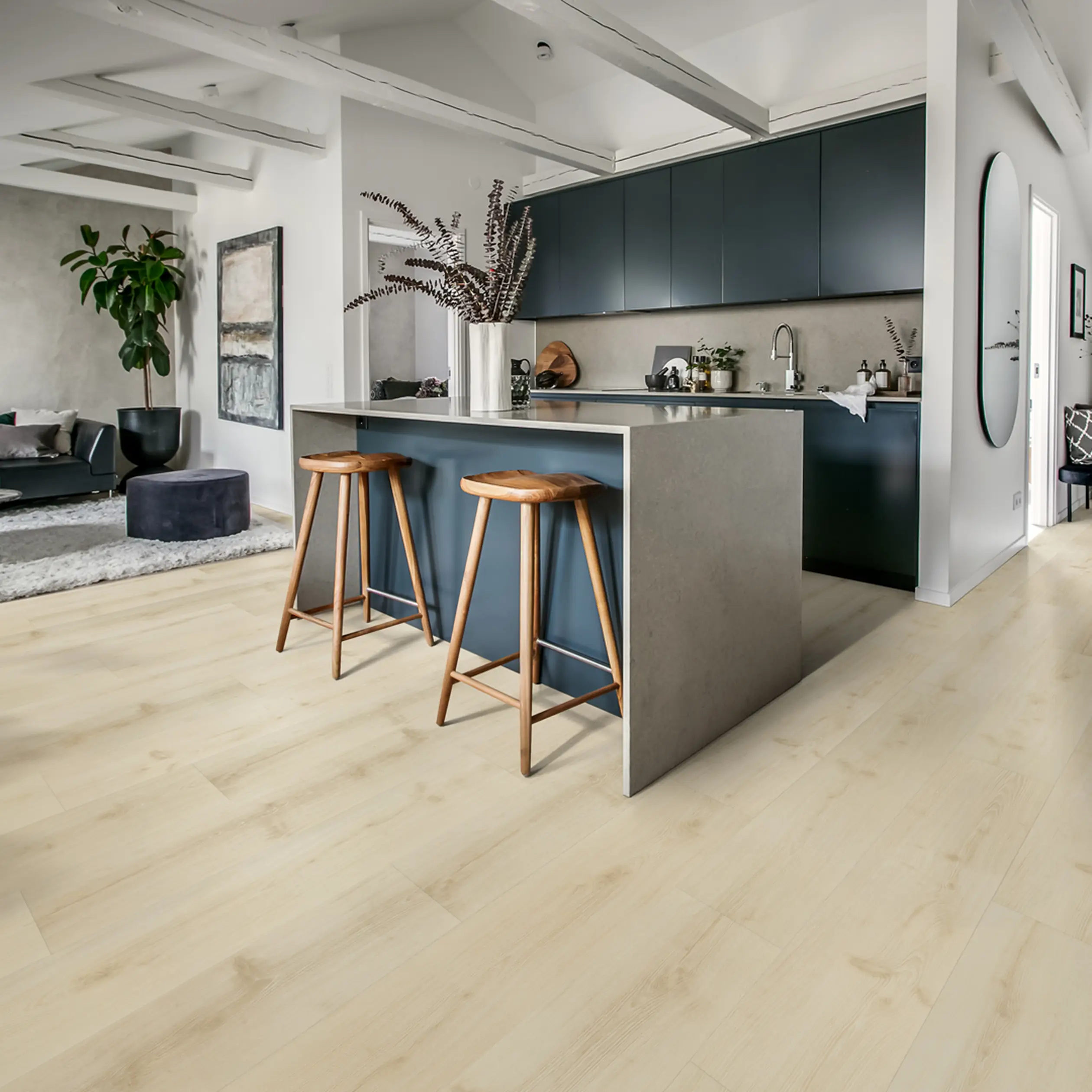 Contemporary kitchen with light wood flooring, dark cabinets, and wooden barstools.