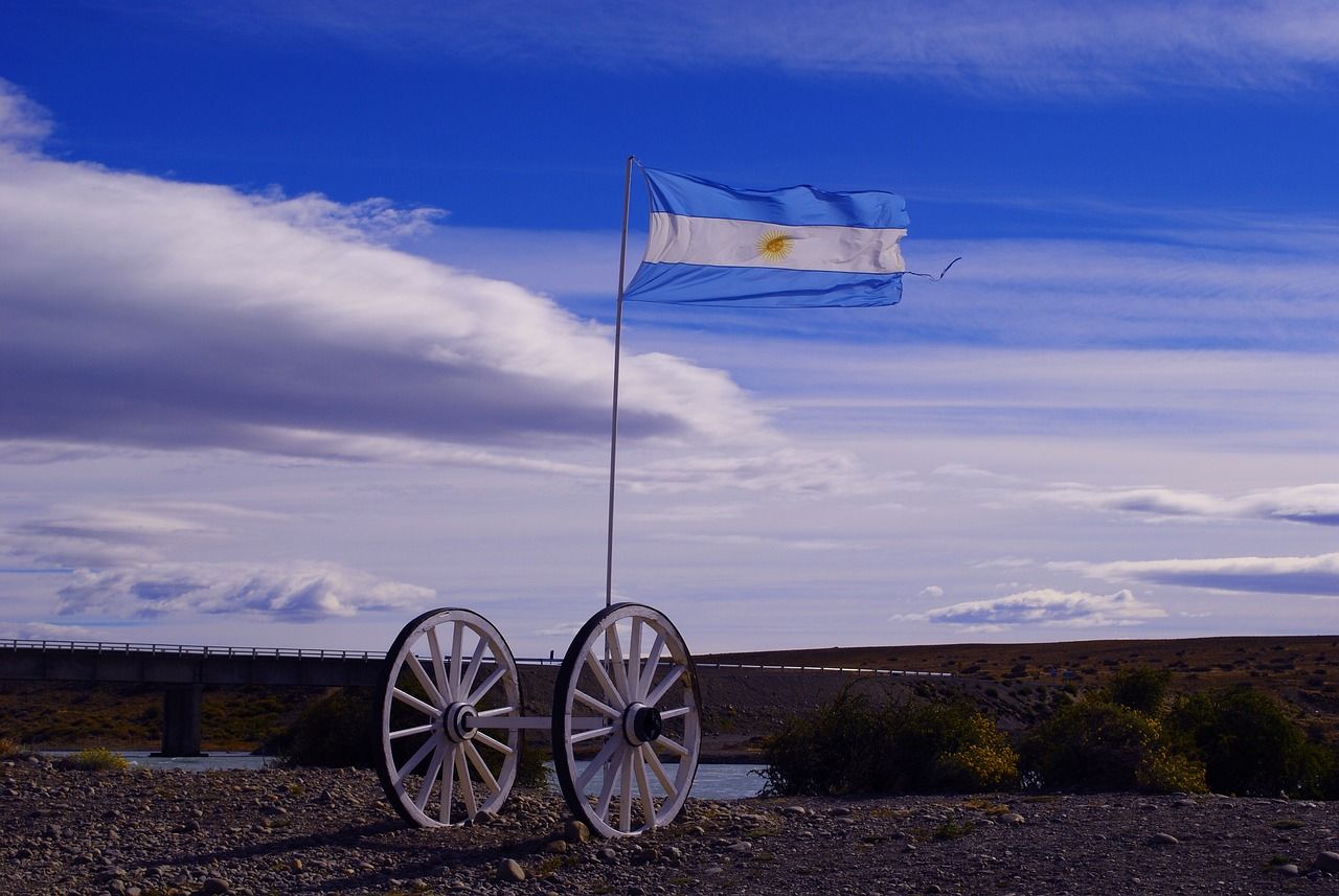 Argentine flag waving on wagon wheels beside the road to El Chaltén, Patagonia.