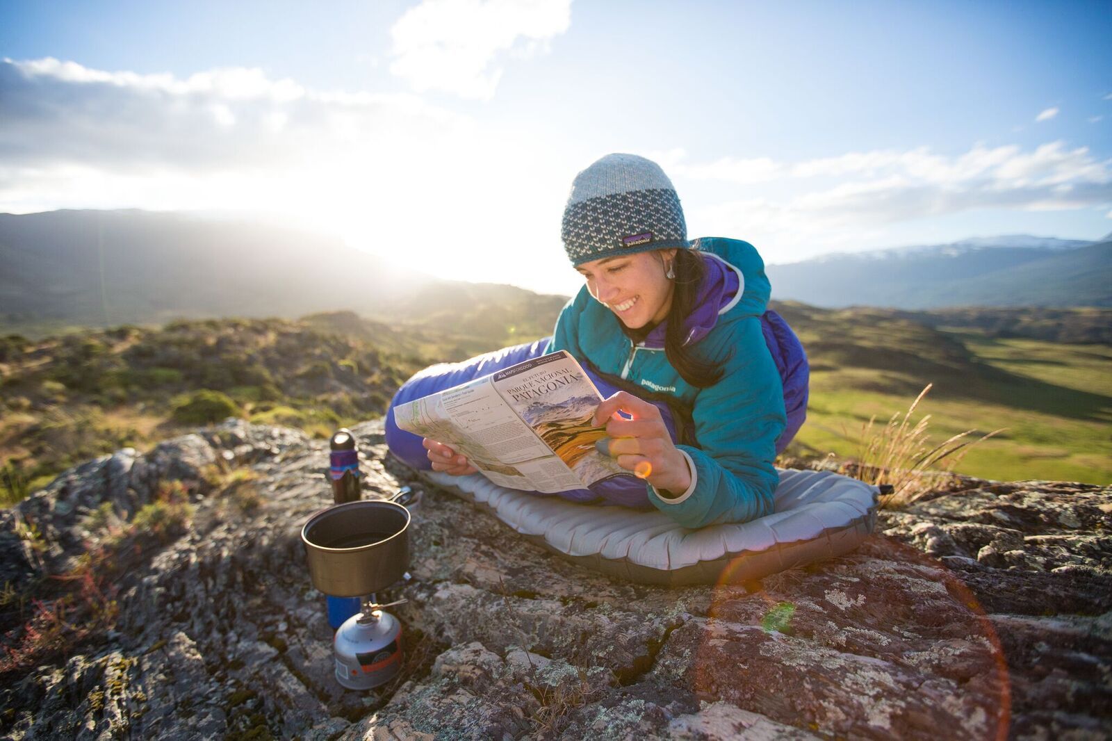 Woman reads a map while planning a trip through Patagonia
