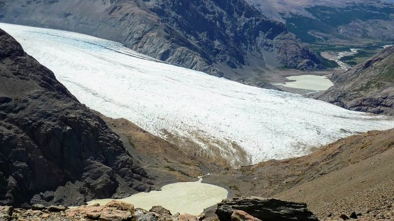Glacier Viedma and turquoise meltwater lake surrounded by rocky peaks along the Circuito Huemul trail near El Chaltén.