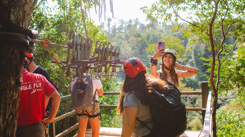 Tourists prepare for a zip-lining adventure in the lush jungle canopy above Iguazú Falls in Argentina.