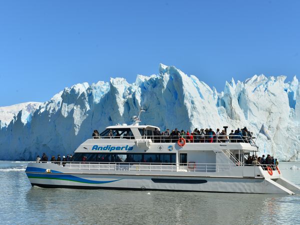 Andiperla boat tour near Perito Moreno Glacier in Patagonia, Argentina with tourists viewing massive ice cliffs.