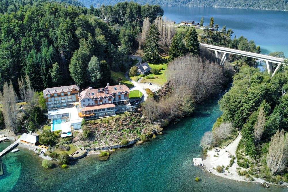 Luxury resort nestled on turquoise waters surrounded by forests in Villa La Angostura, Patagonia.