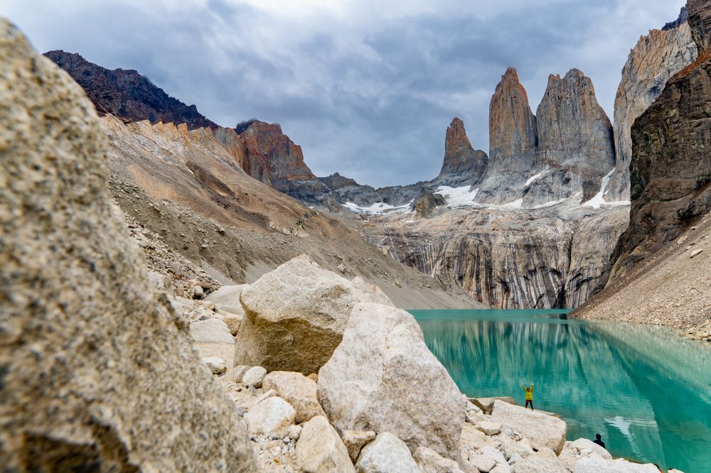 Turquoise glacial lake surrounded by granite peaks at Torres del Paine base trail in Patagonia, Chile.