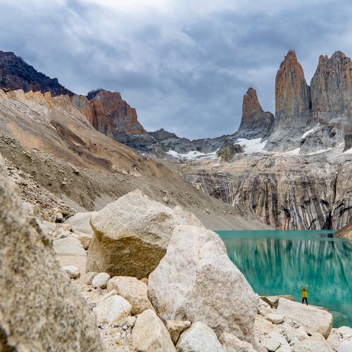 Turquoise glacial lake surrounded by granite peaks at Torres del Paine base trail in Patagonia, Chile.