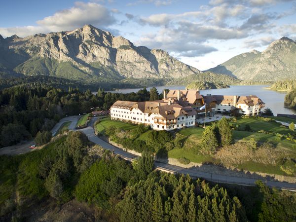 Llao Llao Hotel overlooks pristine lakes surrounded by Patagonian mountains and evergreen forests in Bariloche, Argentina.
